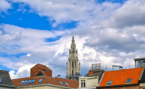 Low angle view of buildings against cloudy sky