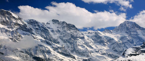 Panoramic view of snowcapped mountains against sky