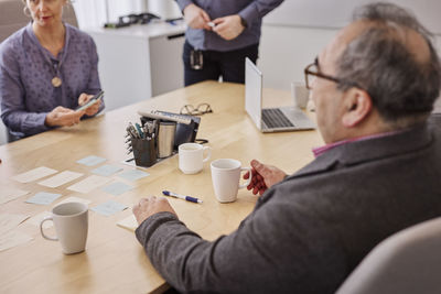 Mature man listening during business meeting