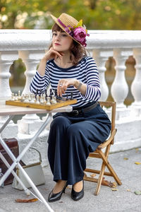 Young woman sitting on chair at home