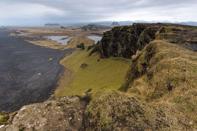 Scenic view of landscape against cloudy sky