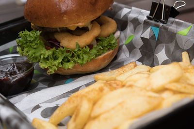 Close-up of food on table burger and fries with souce