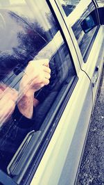 Close-up of hand on window