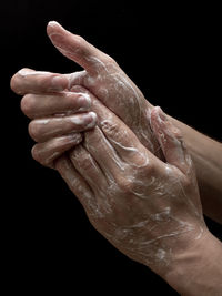 Close-up of human hand against black background