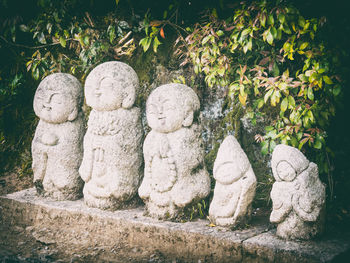 Statues on stone wall