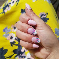 Cropped image of woman showing nail art on fingernails