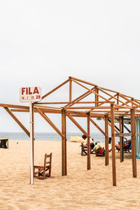 Lifeguard hut on beach against clear sky