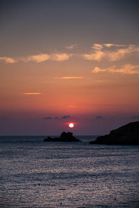 Scenic view of sea against romantic sky at sunset