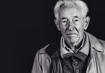 Portrait of man against black background