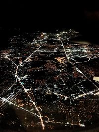 Close-up of illuminated lights against sky at night