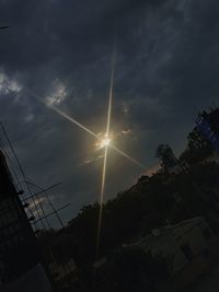 Low angle view of silhouette building against sky