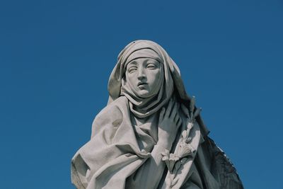 Low angle view of statue against clear blue sky