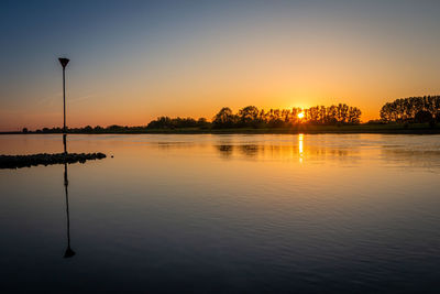 Scenic view of lake against sky during sunset