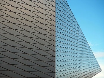 Low angle view of modern building against blue sky