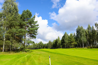Scenic view of golf course against sky
