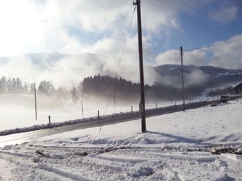 Snow covered landscape against sky