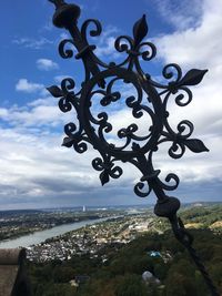 Close-up of metal against sky