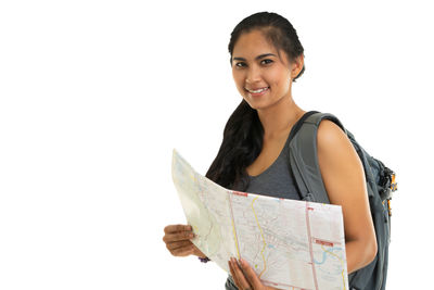 Portrait of smiling young woman against white background