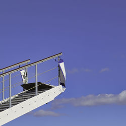 Low angle view of ship against blue sky