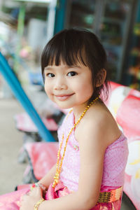 Side view portrait of cute girl smiling outdoors