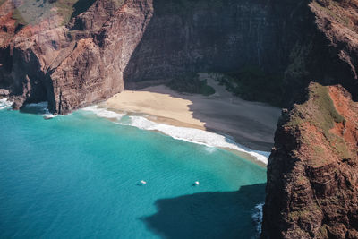 High angle view of rocks on sea shore