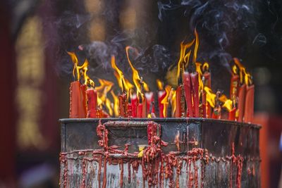 Red candles burning outside buddhist temple