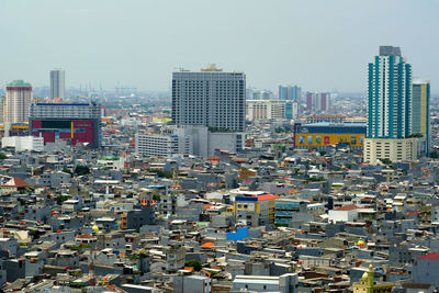 High angle view of buildings in city against sky