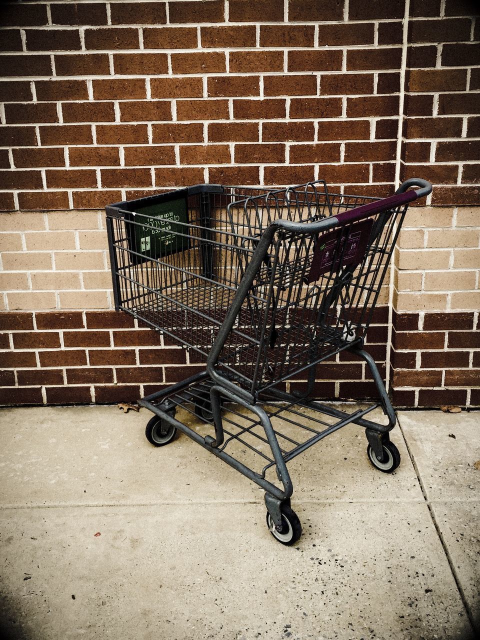 bicycle, wall - building feature, brick wall, sidewalk, metal, transportation, absence, stationary, built structure, architecture, wall, cobblestone, parking, paving stone, abandoned, street, land vehicle, no people, shadow, mode of transport