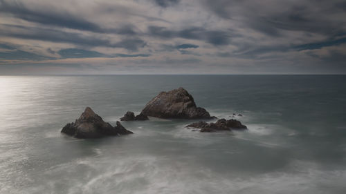 Scenic view of sea against cloudy sky