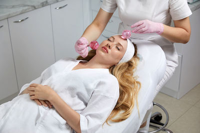 Midsection of doctor examining patient at clinic