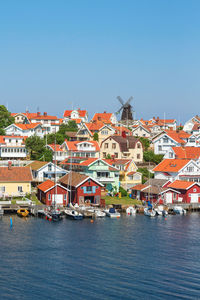 Townscape by river against sky