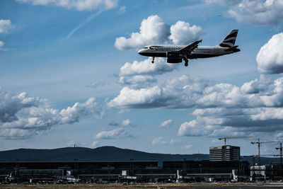 Low angle view of airplane flying against sky