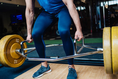 Low section of woman exercising in gym