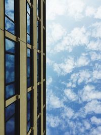 Low angle view of modern building against cloudy sky