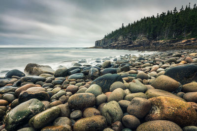 Rocks on beach against sky