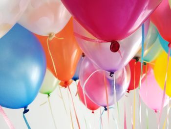 Low angle view of multi colored balloons