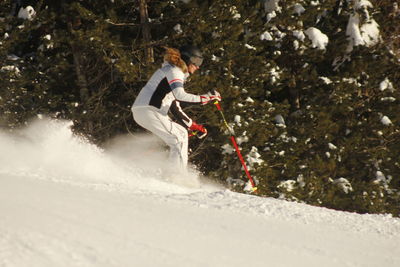 Man skiing on snow covered field