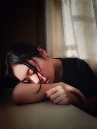 Young woman sleeping on bed at home