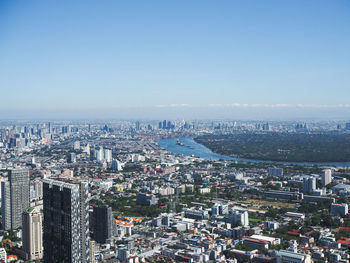 High angle view of city buildings against clear sky