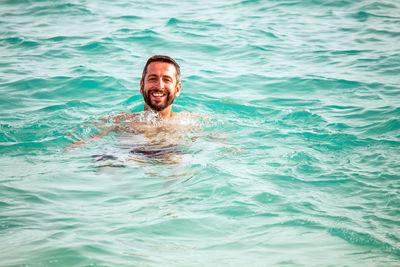 Portrait of man smiling in swimming pool