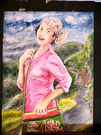 Full length of woman standing against pink wall