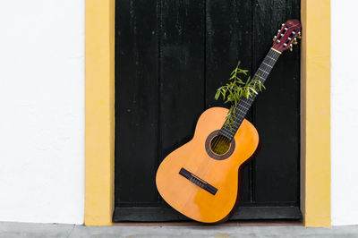 Close-up of guitar by door