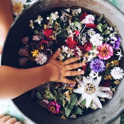 Midsection of woman holding flower bouquet