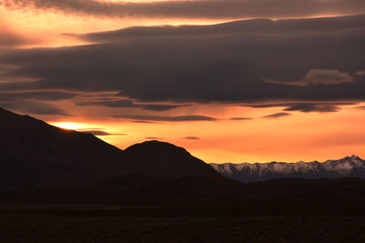 Scenic view of silhouette mountains against sky during sunset