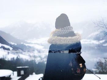 Double exposure image of woman sitting by lake against mountains