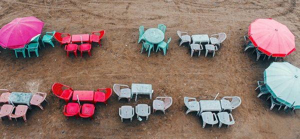 High angle view of empty chairs and tables on field