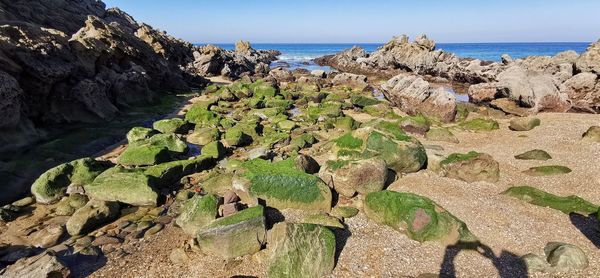 Panoramic view of rocks on beach against sky