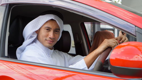 Portrait of young woman in car