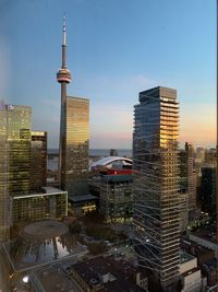 Modern buildings in city during sunset