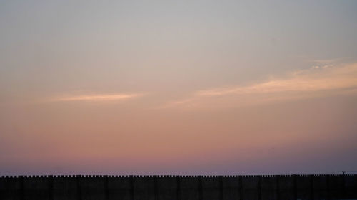 Scenic view of silhouette landscape against sky at sunset